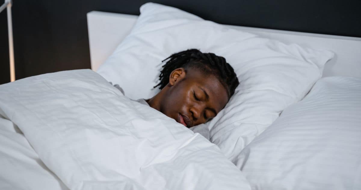 man laying in bed sleeping