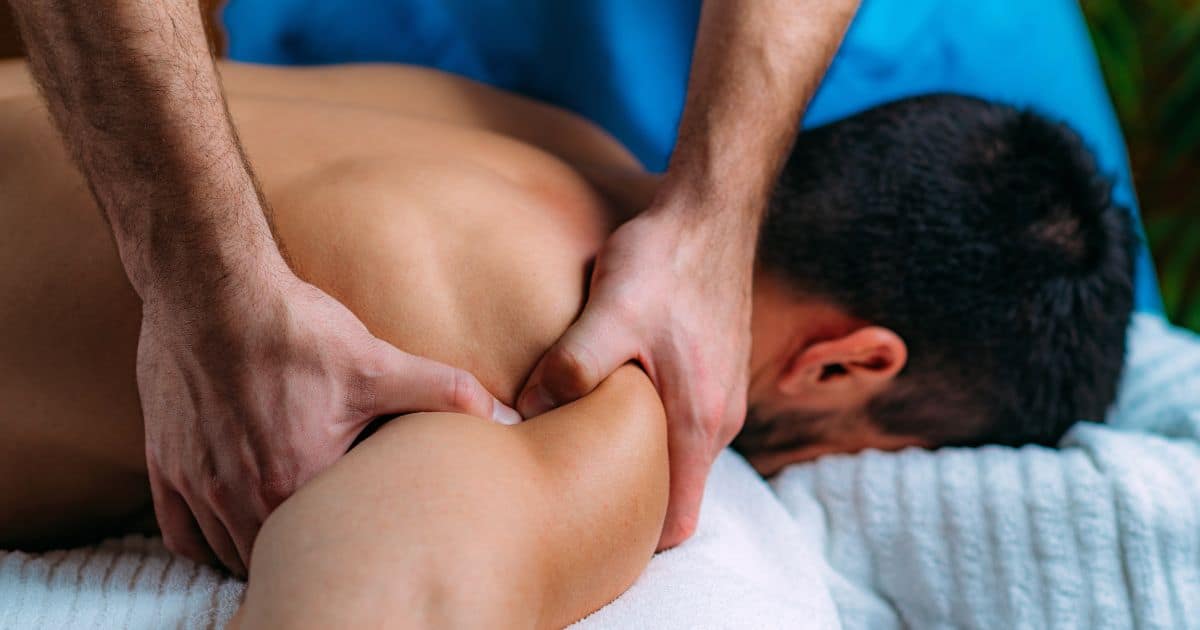 woman massaging mans shoulder