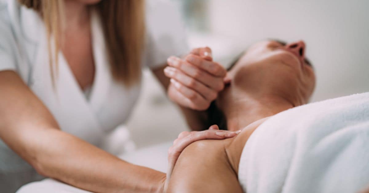therapist stretching clients neck