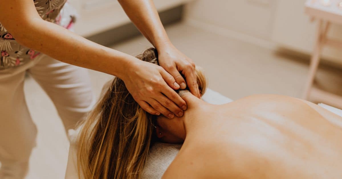 Woman-laying-face-Down-getting-a-neck-Massage
