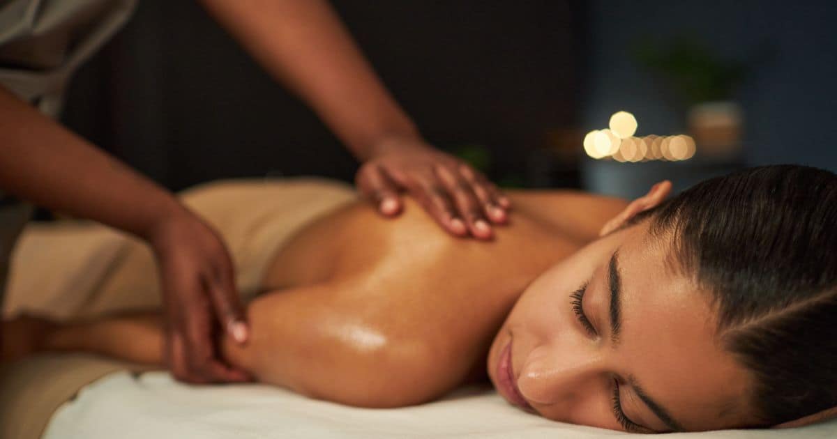 woman laing face down getting a massage