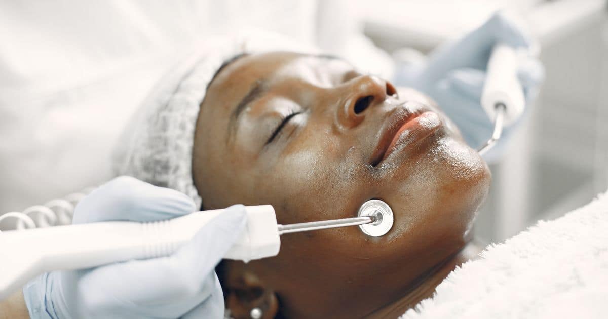 dark skin woman at the spa getting facial
