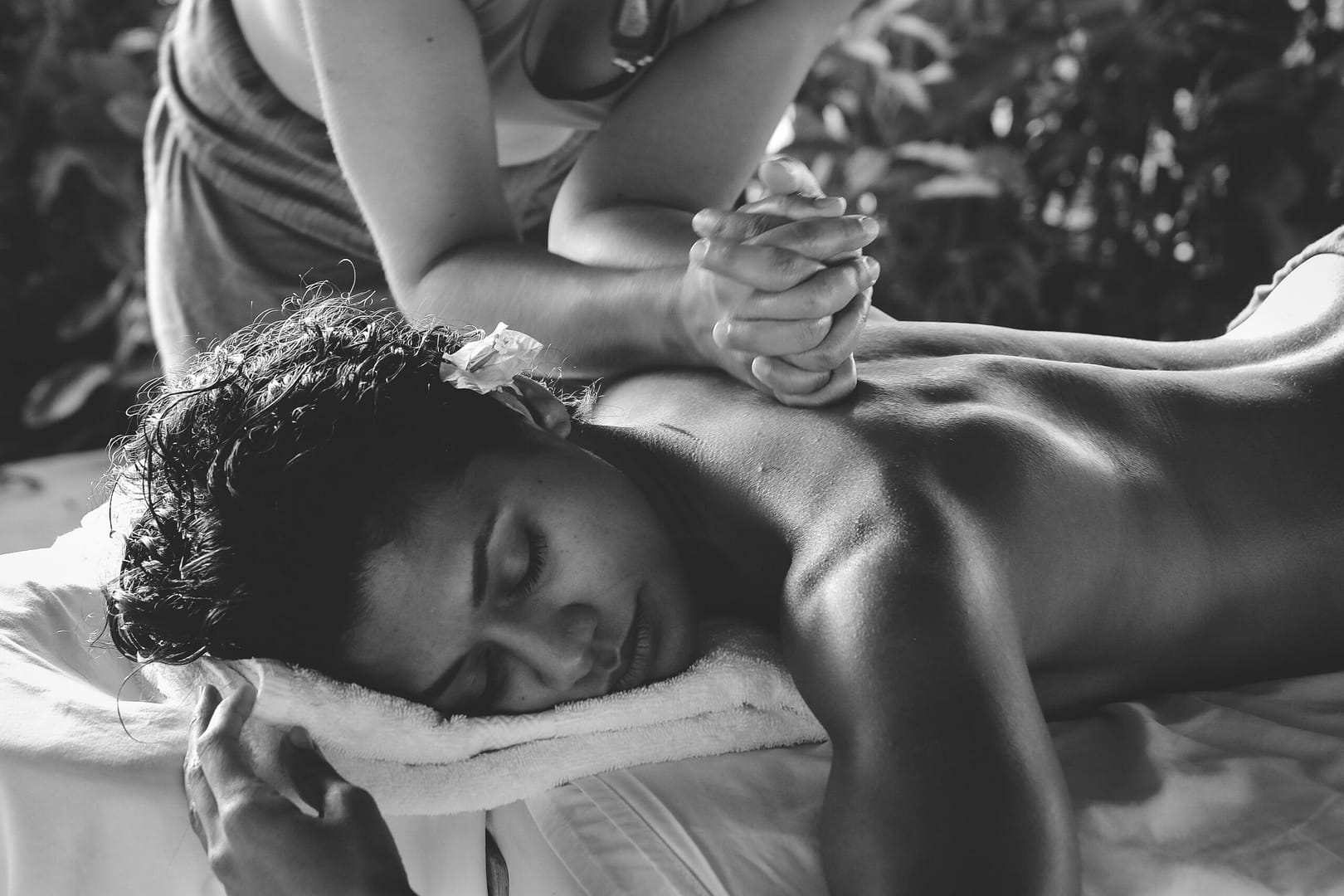 A massage therapist treats a young lady to one of the top spa treatments