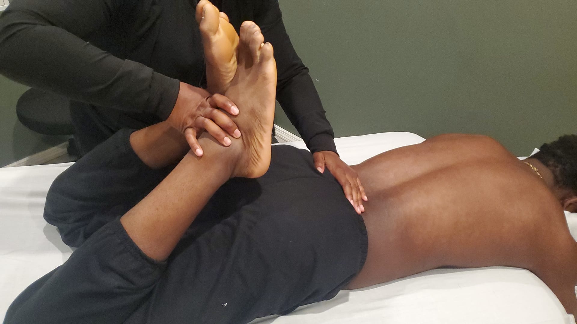 massage therapist stretching clients legs