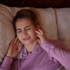 Woman holding her cheeks in pain
