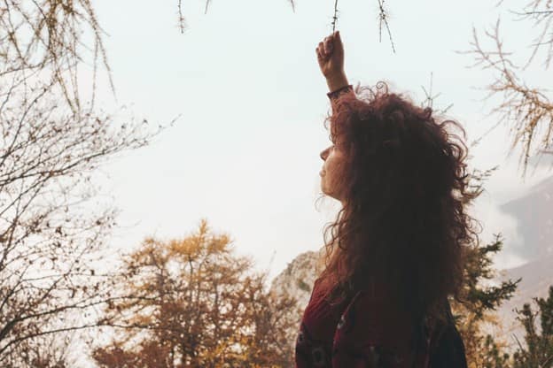 woman holding tree branch