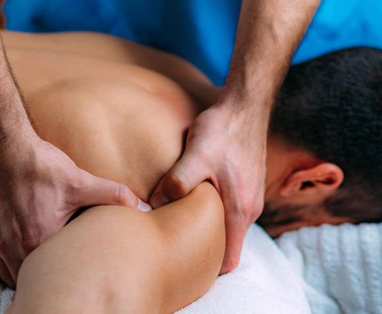 woman massaging mans shoulder