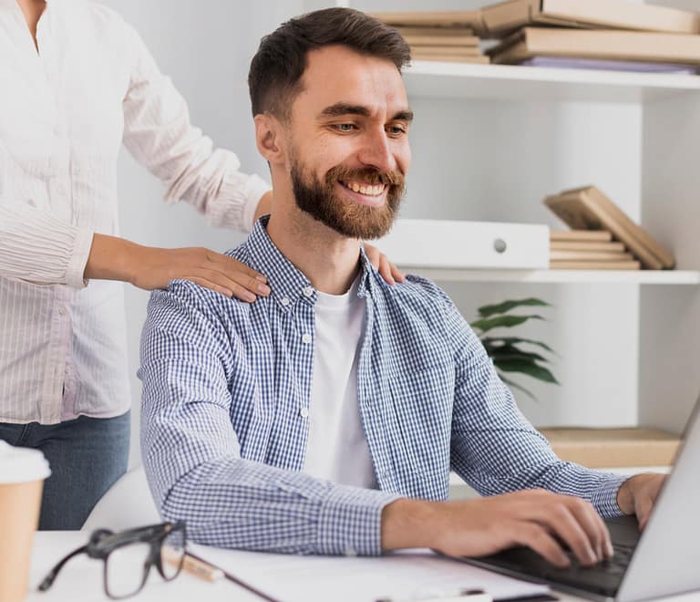 White young male having a massage at work at his desk as part of the employee wellness prgoram