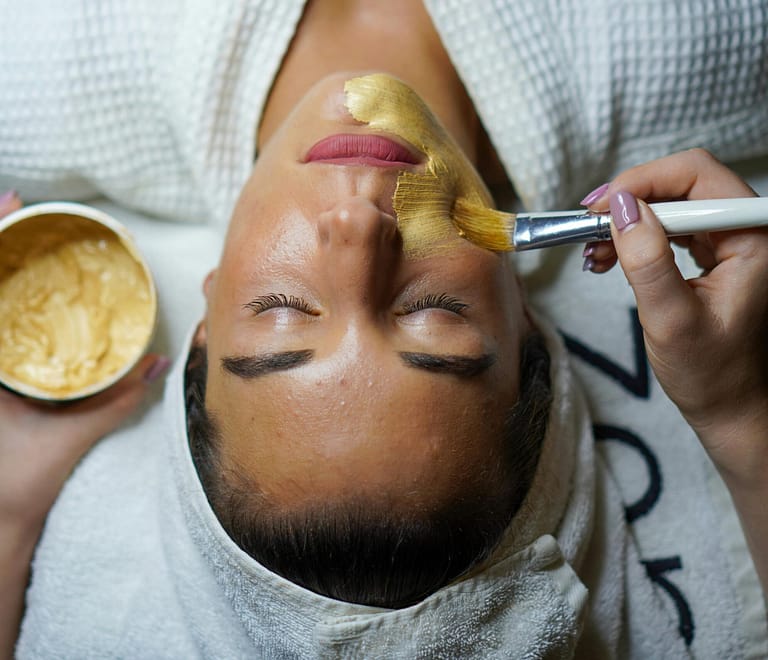 Woman gets 30 minute facial treatment for skin glow in Floral Park on a Spa Bed