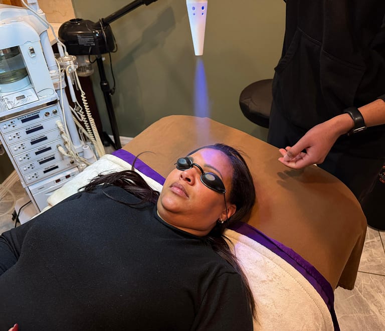 Woman laying on massage table getting Cryo to the face