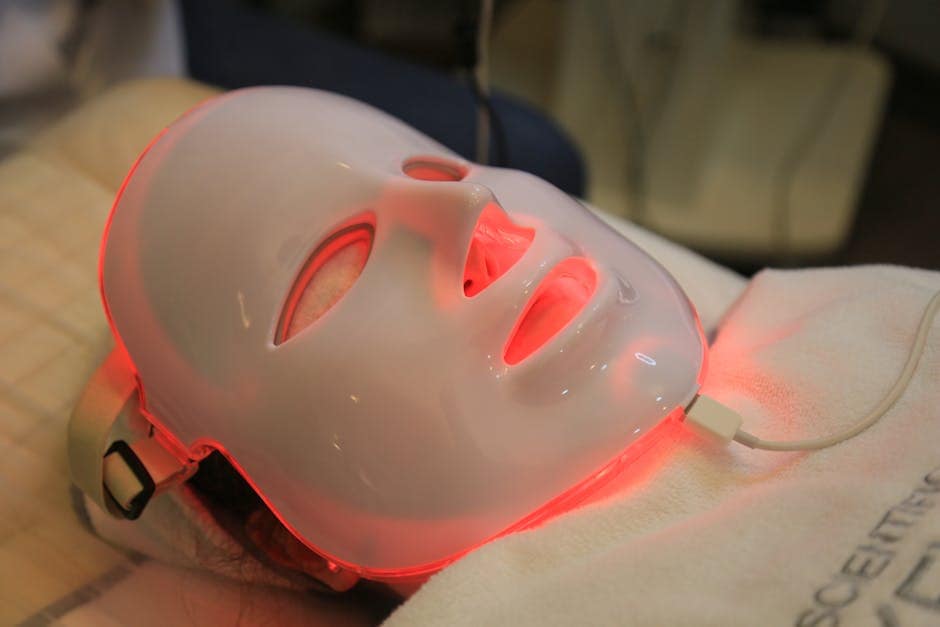 lady laying on her back with a redlight mask