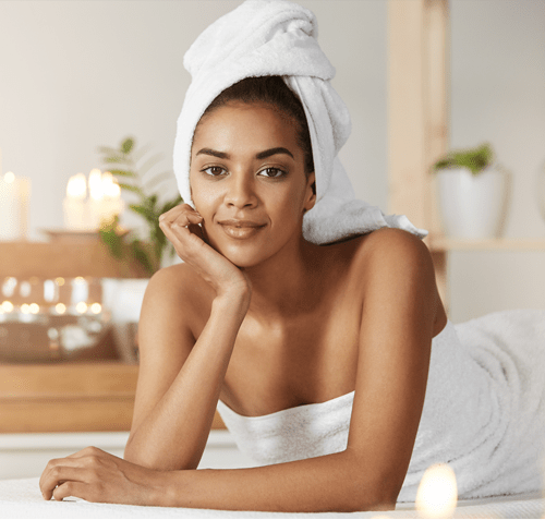 A woman in a towel relaxes