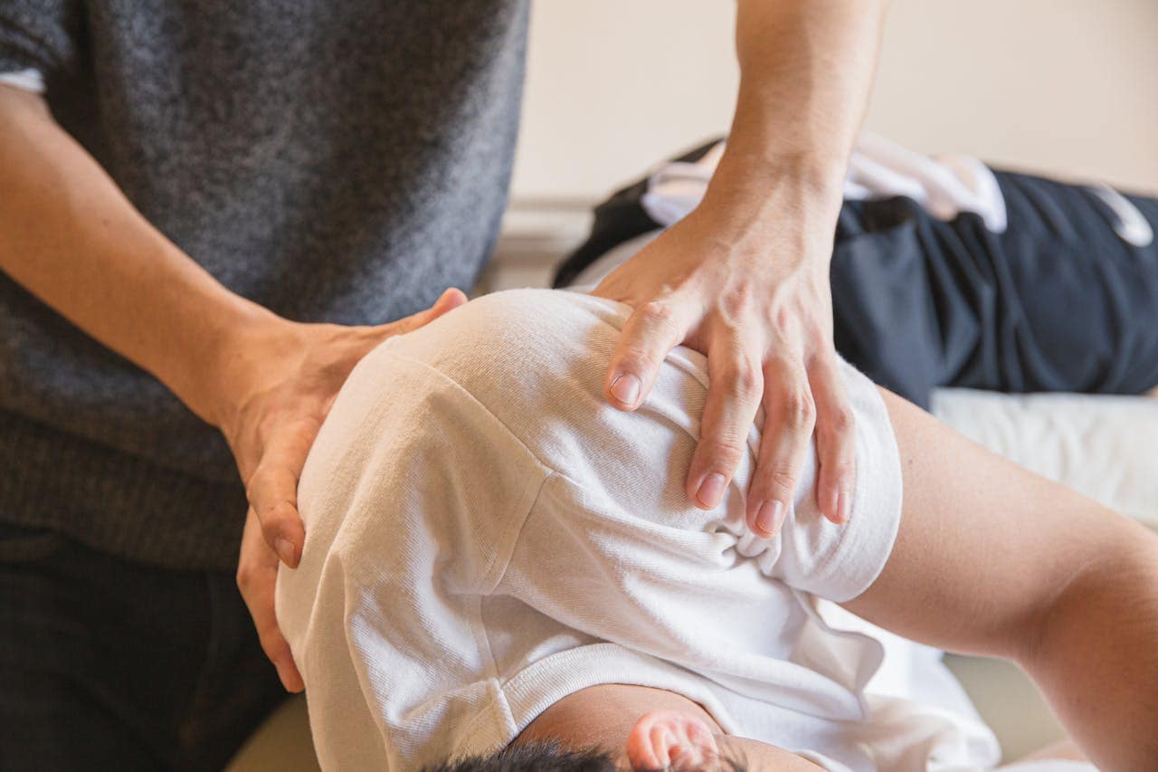 a doctor massaging a patient’s shoulders