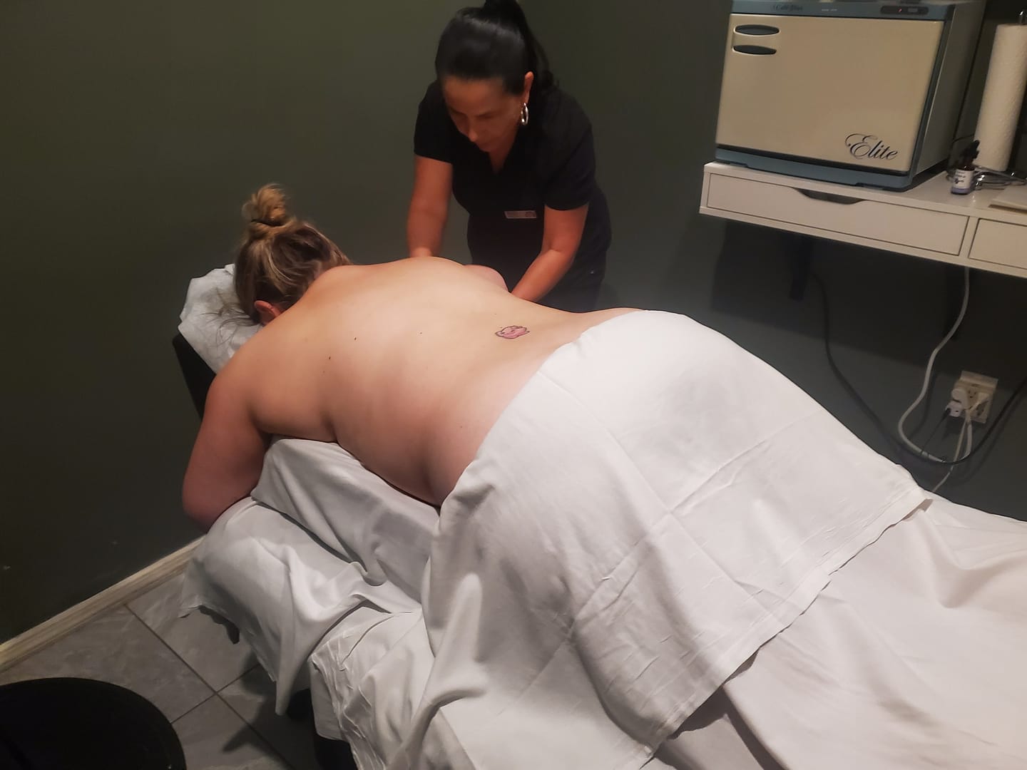 pregnant woman laying face down in the prenatal comfort cushion