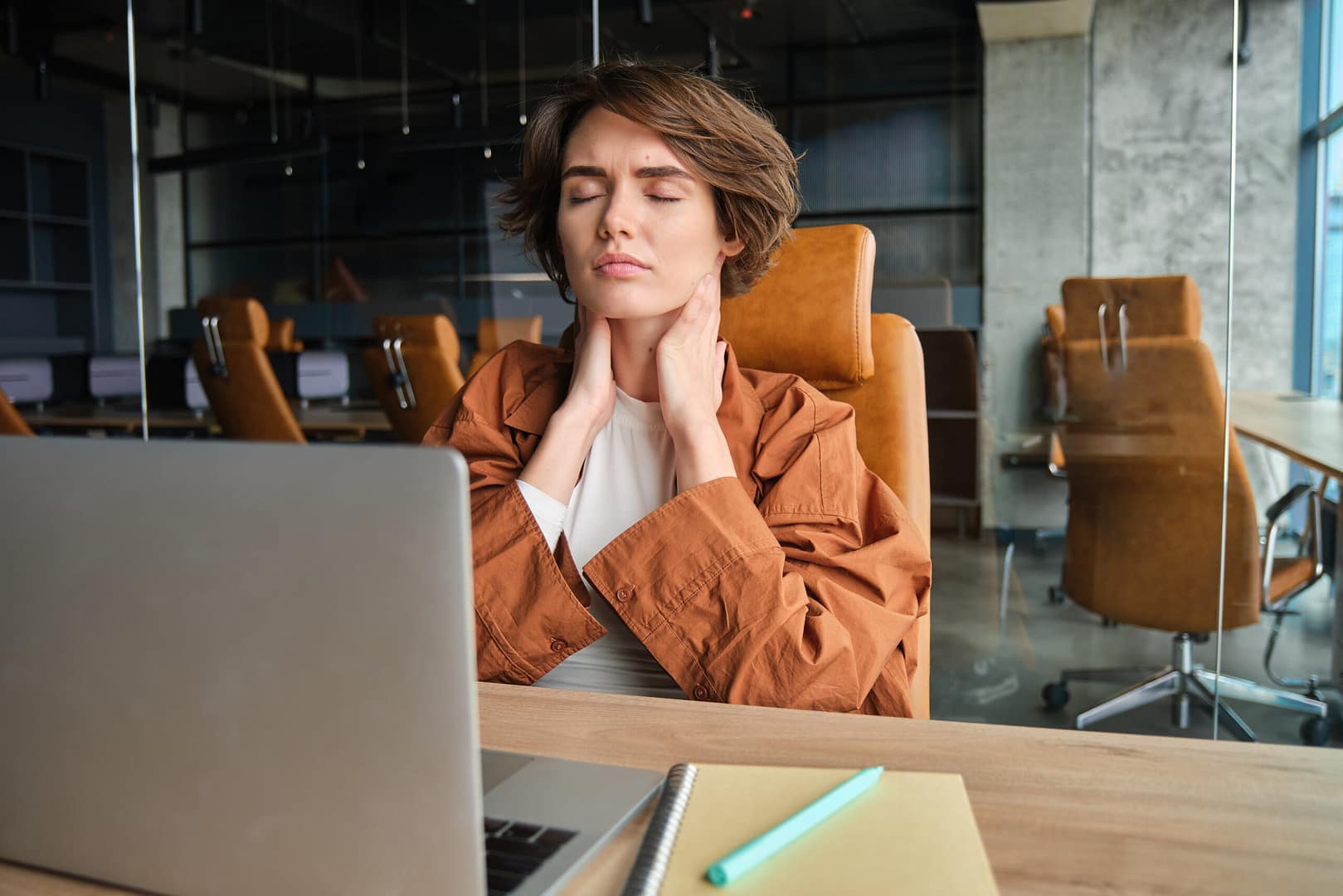 Image of woman feels pain massages her neck feels tension in muscles after long day sitting at desk working and needs massage therapy