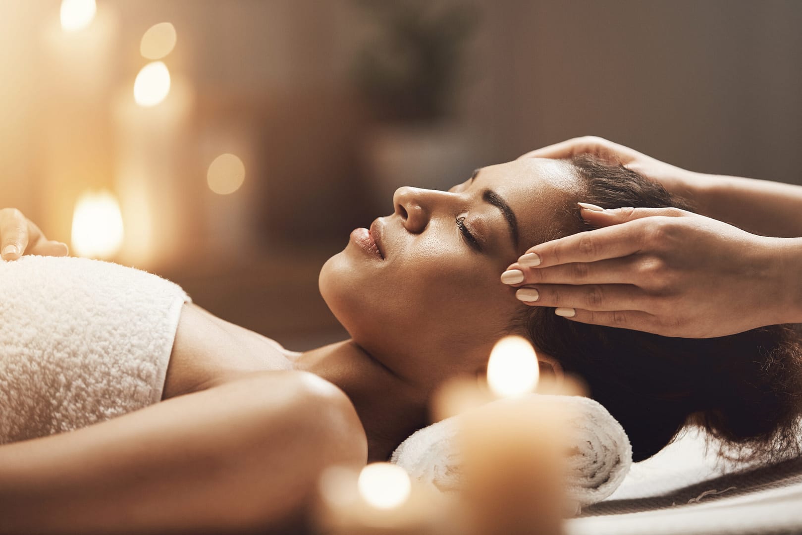 attractive-woman-enjoying-face-massage-to-reduce-burnout-at-spa-salon
