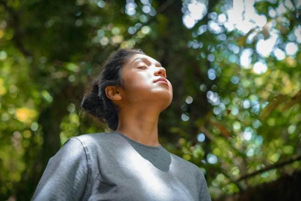 A person practicing a breathing exercise.