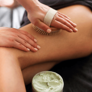 A woman lies on a spa bed with her eyes closed, 