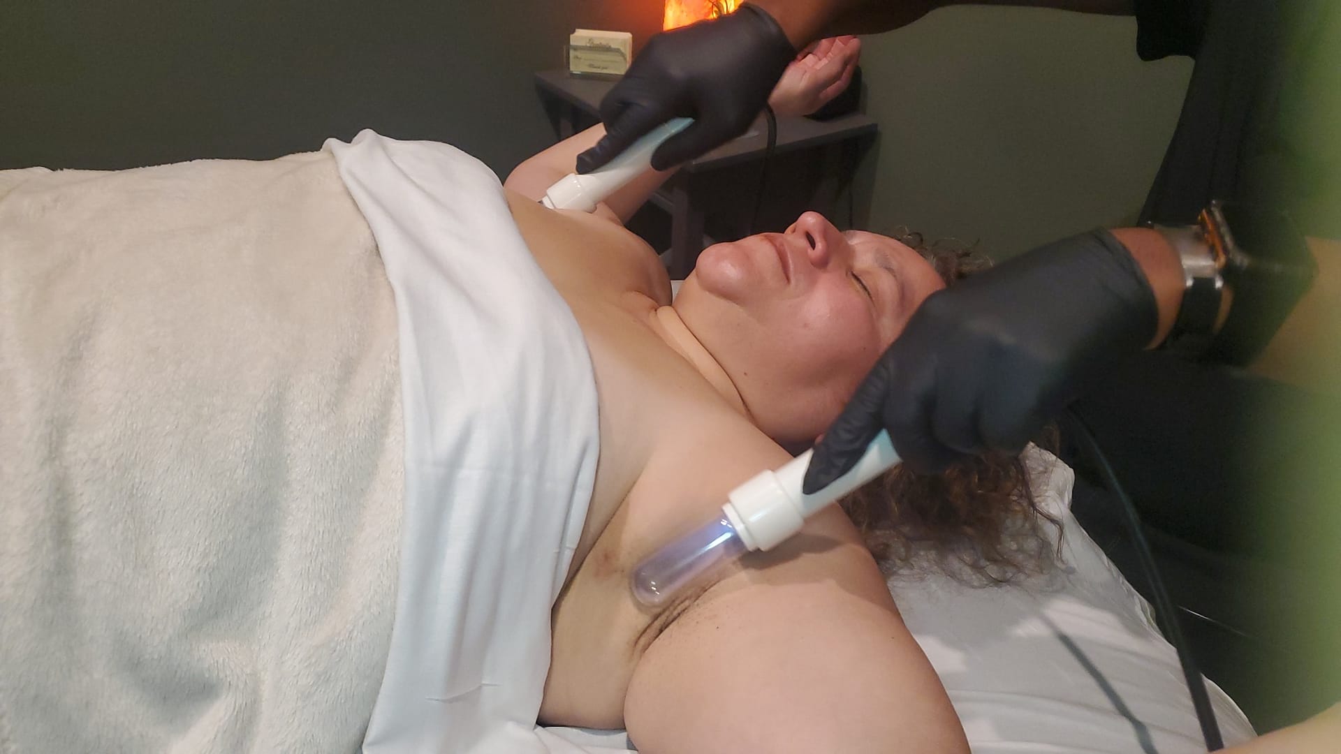 Woman laying on massage table receiving Lymphatic Enhancement Therapy