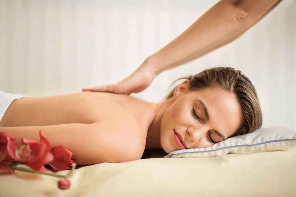 A woman enjoying a relaxing massage with a gentle touch on her back.